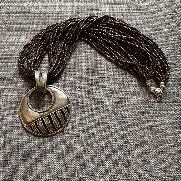 Make a statement with this twisted beaded necklace that has this unique pendant. - Picture 3 of 4